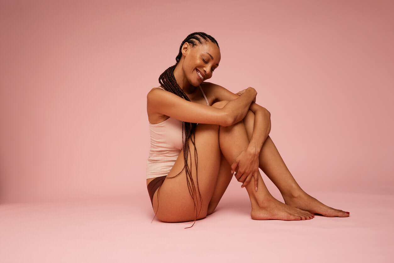 Mulher sentada com as pernas à mostra durante os cuidados sobre como tratar lipedema